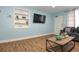 Comfortable living room featuring wood flooring, coastal decor and comfortable grey sofas at 103 Mason Park Dr, Daytona Beach, FL 32117