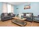 Comfortable living room featuring wood flooring, coastal decor and comfortable grey sofas at 103 Mason Park Dr, Daytona Beach, FL 32117