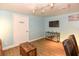 Bright living room featuring hardwood floors, track lighting, wall-mounted television, and comfortable seating at 103 Mason Park Dr, Daytona Beach, FL 32117
