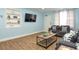 Inviting living room featuring wood flooring, neutral decor and a mounted flat screen television at 103 Mason Park Dr, Daytona Beach, FL 32117