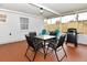 Relaxing screened patio with comfortable seating, a grill, and a privacy fence at 103 Mason Park Dr, Daytona Beach, FL 32117