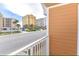 Balcony featuring a street view and condo buildings in a sunny coastal neighborhood at 106 Oceans Cir, Daytona Beach, FL 32118