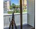 Balcony overlooking the street with palm trees and buildings on a sunny day at 106 Oceans Cir, Daytona Beach, FL 32118