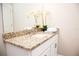 Bright bathroom showcasing granite countertops, a modern sink, and a decorative floral arrangement at 106 Oceans Cir, Daytona Beach, FL 32118