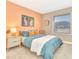 Comfortable bedroom showcasing bright walls, complementing art, and natural light from a large window at 106 Oceans Cir, Daytona Beach, FL 32118
