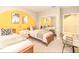 Comfortable bedroom featuring two beds, a mirrored closet, and a bright, cheerful accent wall at 106 Oceans Cir, Daytona Beach, FL 32118