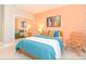 Stylish bedroom features vibrant coral walls and coordinating blue bedding for a cozy, modern aesthetic at 106 Oceans Cir, Daytona Beach, FL 32118