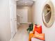 Bright hallway with tile flooring, decorative mirror, bench, and colorful pillows for a welcoming entrance at 106 Oceans Cir, Daytona Beach, FL 32118