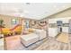 Open-concept living area featuring modern decor, hardwood floors, and a kitchen with white cabinets at 106 Oceans Cir, Daytona Beach, FL 32118