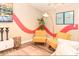 Open living area with decor, comfortable seating, a tree, and unique flamingo art at 106 Oceans Cir, Daytona Beach, FL 32118