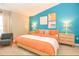 Stylish bedroom with striking turquoise wall, comfortable seating and coordinated artwork at 106 Oceans Cir, Daytona Beach, FL 32118