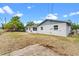 View of the home's exterior with a large backyard and patio area perfect for outdoor activities at 10900 Tangora St, Orlando, FL 32825