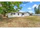 Large backyard featuring a patio and partial fencing, ideal for gatherings and outdoor enjoyment at 10900 Tangora St, Orlando, FL 32825