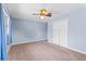 Comfortable bedroom features light blue walls, a ceiling fan, and a large closet at 10900 Tangora St, Orlando, FL 32825