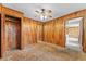 Bedroom featuring wood paneling, ceiling fan, and a closet at 10900 Tangora St, Orlando, FL 32825