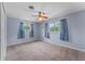 This cozy bedroom has blue walls and curtains, two windows, and a ceiling fan at 10900 Tangora St, Orlando, FL 32825