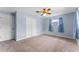 This bedroom offers light blue walls, a ceiling fan, and a double door closet at 10900 Tangora St, Orlando, FL 32825