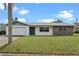 Charming single-story home featuring a well-maintained lawn and a mix of stone and siding details at 10900 Tangora St, Orlando, FL 32825