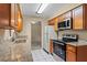 Efficient kitchen featuring granite countertops and wood cabinets providing ample storage at 10900 Tangora St, Orlando, FL 32825