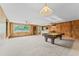 Spacious living room featuring a pool table, bar, and wood paneled walls at 10900 Tangora St, Orlando, FL 32825
