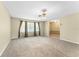 Bright living room featuring neutral carpeting and large windows for ample natural light at 10900 Tangora St, Orlando, FL 32825