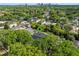 Aerial view of home with dark roof surrounded by mature trees and green lawns at 1136 W Harvard St, Orlando, FL 32804