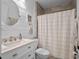 Bright bathroom featuring updated sink, vanity, and shower with tan tile at 1136 W Harvard St, Orlando, FL 32804