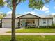 Charming exterior of home with a metal roof, landscaped lawn, and a lovely front porch sitting area at 1136 W Harvard St, Orlando, FL 32804