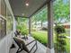 Inviting covered front porch with a relaxing seating area overlooking the front lawn at 1136 W Harvard St, Orlando, FL 32804
