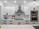 Bright kitchen with white cabinets, stainless steel appliances, white subway tile, and a modern range hood at 1136 W Harvard St, Orlando, FL 32804