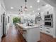 Eat-in kitchen with stainless steel appliances, large island with bar seating and white cabinetry at 1136 W Harvard St, Orlando, FL 32804