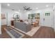 Bright living room featuring hardwood floors, a stylish rug, neutral decor, and a ceiling fan at 1136 W Harvard St, Orlando, FL 32804