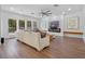 Living room with a modern fireplace, a large sectional sofa, and large windows for natural light at 1136 W Harvard St, Orlando, FL 32804