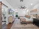 Bright bedroom with ceiling fan, lamps, and natural light and barn door access to bathroom at 1136 W Harvard St, Orlando, FL 32804