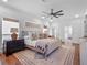 Bright and airy bedroom with ceiling fan, lamps, and natural light at 1136 W Harvard St, Orlando, FL 32804