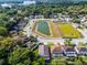 Aerial view of the neighborhood showcasing a tranquil pond and well-maintained lawns at 150 Golfside Cir, Sanford, FL 32773