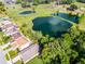 Aerial view of home backing onto lush green golf course and scenic ponds at 150 Golfside Cir, Sanford, FL 32773