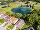 Aerial view of home backing onto lush green golf course and scenic ponds at 150 Golfside Cir, Sanford, FL 32773