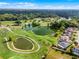 Aerial view featuring community golf course, pond and well-maintained homes at 150 Golfside Cir, Sanford, FL 32773
