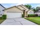Charming home exterior with well-manicured lawn and attached two-car garage at 150 Golfside Cir, Sanford, FL 32773