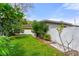 Green backyard with vibrant green grass, a white fence, and various trees at 1500 Pinecrest Pl, Orlando, FL 32803