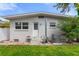 Home backyard featuring well-kept lawn and concrete steps to back door at 1500 Pinecrest Pl, Orlando, FL 32803