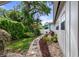 Landscaped backyard featuring a stone path between the home and privacy fence at 1500 Pinecrest Pl, Orlando, FL 32803