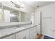 Bright bathroom featuring a modern vanity, granite counters, and a tiled shower at 1500 Pinecrest Pl, Orlando, FL 32803