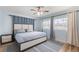 Light and airy bedroom with hardwood floors, neutral color palette, and two large windows at 1500 Pinecrest Pl, Orlando, FL 32803