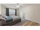 Neutral bedroom featuring hardwood floors, ceiling fan, and bathroom access at 1500 Pinecrest Pl, Orlando, FL 32803