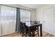 Well-lit dining area with hardwood floors, a stylish table, and large windows at 1500 Pinecrest Pl, Orlando, FL 32803