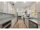 Well-lit kitchen featuring stone countertops and modern stainless steel appliances at 1500 Pinecrest Pl, Orlando, FL 32803
