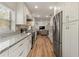Spacious kitchen with modern appliances, wood floors, and an open floor plan at 1500 Pinecrest Pl, Orlando, FL 32803