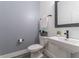 Powder room featuring gray walls, a modern sink, decorative plant, and fresh towels at 15313 Lebeau Loop, Winter Garden, FL 34787